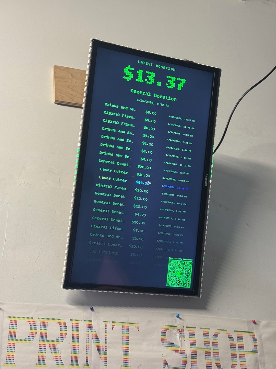 Image of a screen mounted to a wall showing a log of donation amounts